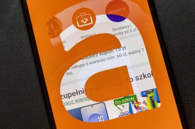 Warsaw Poland - September 16 2025: Close-up of a smartphone displaying an online shopping app Allegro interface with a prominent letter a and vibrant orange background.