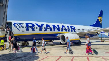 Alicante Spain - July 17 2025: Passengers board a Ryanair airplane at the airport under clear blue skies showcasing summer travel excitement and mobility.