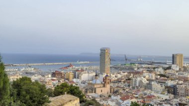 A panoramic view of Alicante showcasing the vibrant cityscape with modern buildings the marina and the sea. This picturesque coastal city offers a perfect blend of architecture and nature.