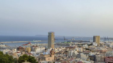 A panoramic view of Alicante showcasing the vibrant coastal city with unique architecture bustling harbor and scenic seafront under a clear sky perfect for tourism and travel.