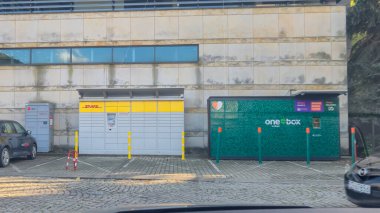 Rzeszow Poland - September 15 2025: Two parcel lockers are visible in a public space featuring DHL and one e-box signage suitable for delivery and pickup services.