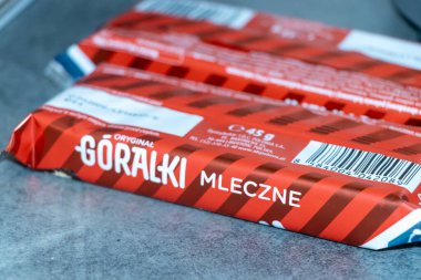 Warsaw Poland - September 24 2025: Close-up of Goralek Mleczne snack packaging featuring red stripes a popular Polish chocolate biscuit suitable for various occasions.
