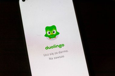 Warsaw Poland - September 24 2025: A close-up view of the Duolingo app interface on a smartphone screen displaying its logo and slogan in Polish promoting free language learning.
