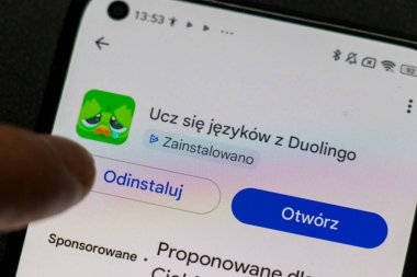 Warsaw Poland - September 24 2025: Close-up of a smartphone screen displaying the Duolingo language learning app with installation status and options.