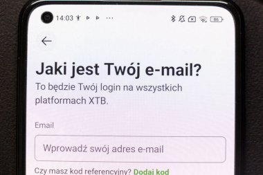 Warsaw Poland - September 24 2025: Close-up of a smartphone displaying a login interface asking for an email address part of the XTB platform setup process.