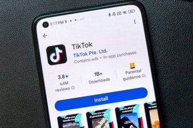 Warsaw Poland - September 24 2025: Smartphone screen displaying TikTok application features highlighting reviews and download count popular social media platform for short videos.