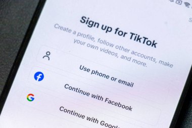 Warsaw Poland - September 24 2025: Mobile device screen displaying a sign-up page for TikTok illustrating digital connectivity and social media engagement.
