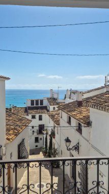 Altea Spain - July 17 2025: Scenic view of whitewashed houses with tiled roofs overlooking the Mediterranean Sea creating a picturesque coastal atmosphere in Altea.