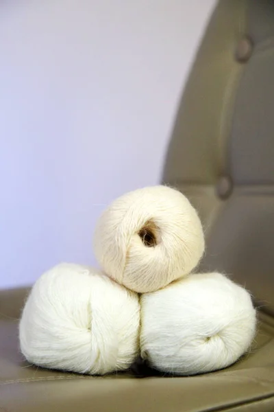 balls of woolen threads and knitwear