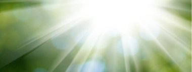 Abstract image of sun rays on a green blurred background