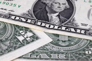 Image of one dollar bills lying in disarray