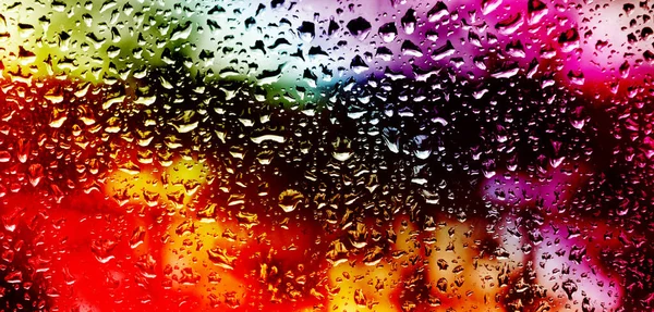 Image of window pane with raindrops all over