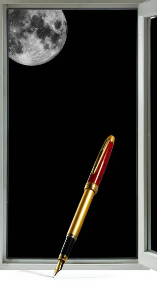 Image of a pen against the background of a window and the moon in a black sky