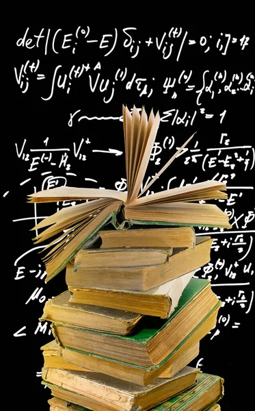 Image of a stack of old books and an open book on top of the stack with math symbols, formulas and expressions in the background. Science and Education