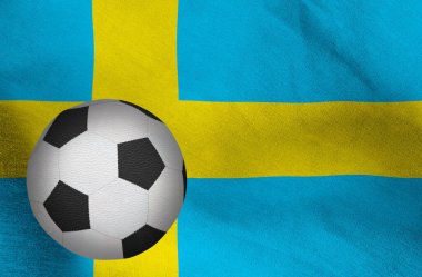 İsveç bayrağının arka planında bir futbol topunun görüntüsü