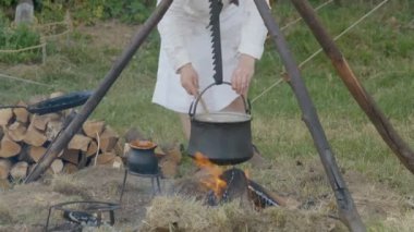 Scenes in medieval costume, a priest smiling at the Trecentesca festival on June 21, 2022 in Morimondo, Italy