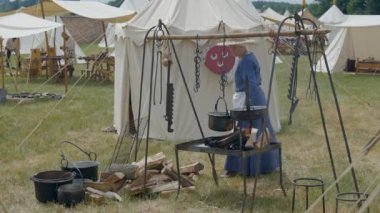 Scenes in medieval costume, a priest smiling at the Trecentesca festival on June 21, 2022 in Morimondo, Italy