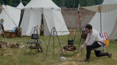 Scenes in medieval costume, a priest smiling at the Trecentesca festival on June 21, 2022 in Morimondo, Italy