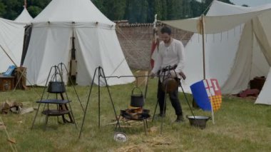 Scenes in medieval costume, a priest smiling at the Trecentesca festival on June 21, 2022 in Morimondo, Italy