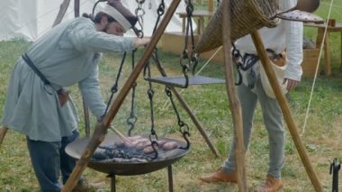 Scenes in medieval costume, a priest smiling at the Trecentesca festival on June 21, 2022 in Morimondo, Italy