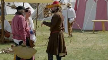 Scenes in medieval costume, two lords and a lady talking in a medieval camp on June 21, 2022 in Morimondo, Italy