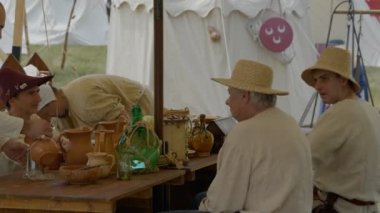 Scenes in medieval costume, peasants eating under a tent in a medieval camp on June 21, 2022 in Morimondo, Italy