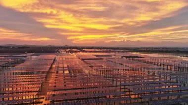 Kırsal alandaki güneş panelleri ve dramatik günbatımı gökyüzü manzarası