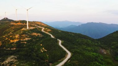 Dağlardaki rüzgar enerji istasyonunda dönen rüzgar türbinleri. Hava görünümü.