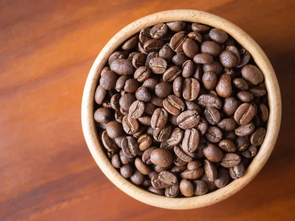 stock image brown arabica coffee bean roast level medium taste delicate lively bright seed caffeine espresso drink food cafe beverage Chiang Rai, Thailand coffee on wooden table background top view selected focus