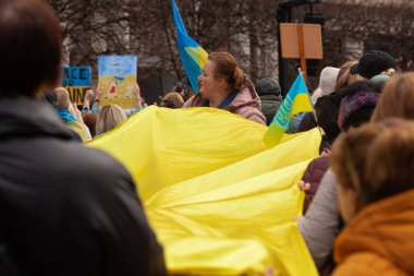 Dublin, Co. Dublin, Ireland - February 24th 2023 - Ukrainians and supporters rally. The first anniversary of Russia's invasion of Ukraine. O'Connell street near GPO. Woman holding Ukrainian flag