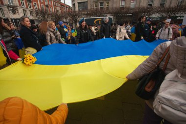 Dublin, Co. Dublin, Ireland - February 24th 2023 - Ukrainians and supporters rally. The first anniversary of Russia's invasion of Ukraine. O'Connell st near GPO. People hold Ukrainian flag. Text space