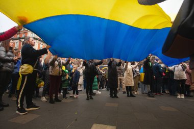 Dublin, Co. Dublin, Ireland - February 24th 2023 - Ukrainians and supporters rally. The first anniversary of Russia's invasion of Ukraine. O'Connell street near GPO. People hold huge Ukrainian flag