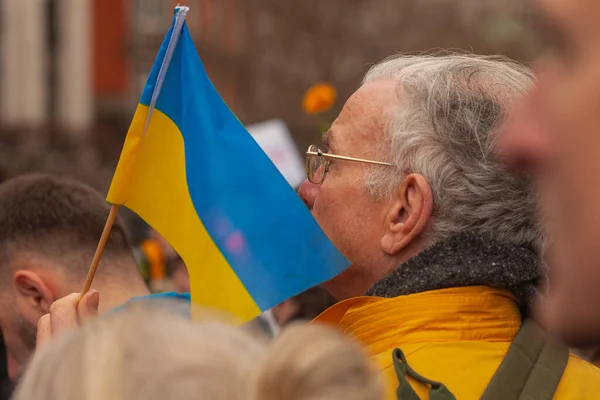 stock image Dublin, Co. Dublin, Ireland - February 24th 2023 - Ukrainians and supporters rally. The first anniversary of Russia's invasion of Ukraine. O'Connell street near GPO. Old man holding flag