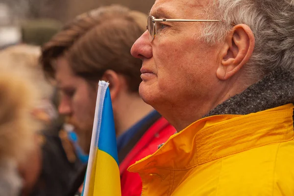 stock image Dublin, Co. Dublin, Ireland - February 24th 2023 - Ukrainians and supporters rally. The first anniversary of Russia's invasion of Ukraine. O'Connell street near GPO. Old man holding flag