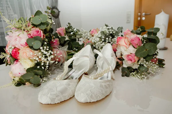 Women\'s shoes of the bride and flower. Selective focus.