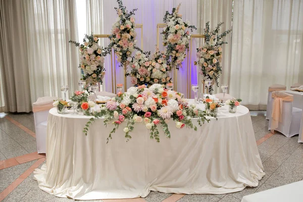 Wedding table with favors and flowers. Elegance wedding decor.