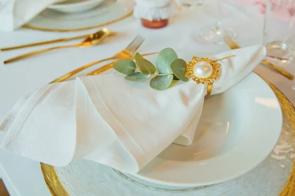 Wedding brunch table setting with a napkin on a plate. Elegance wedding decor. Close-up.