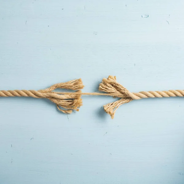 Rope Tearing Apart Just Small String Still Attached Blue Background — Stock Photo, Image