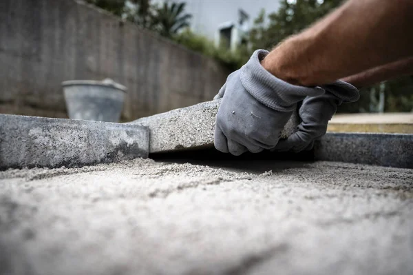 Low Angle View Worker Wearing Protective Gloves Placing Cement Tile Stock Image