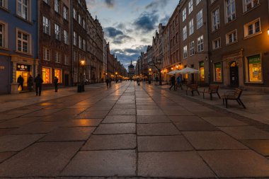 Gdansk, Poland - April 2022: Dluga street full of small shops and restaurants next to market square 