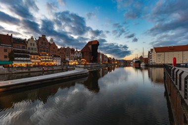Gdansk, Poland - April 2022: Beautiful panorama of city over Motlawa river at cloudy sunset