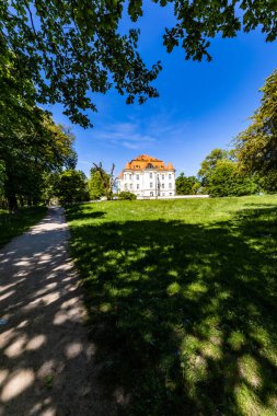 Wroclaw, Poland - May 2022: Beautiful an old castle in Lesnica with a cultural center with exhibitions of works by Polish artists and illustrators with colorful park around