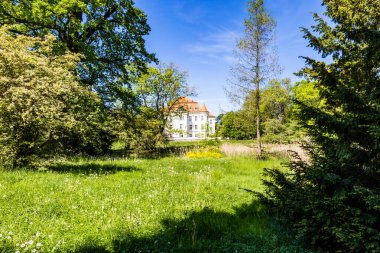 Wroclaw, Poland - May 2022: Beautiful an old castle in Lesnica with a cultural center with exhibitions of works by Polish artists and illustrators with colorful park around