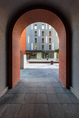 Wroclaw, Polonya - Haziran 2022: Yeni bir konut binasının girişi olarak kırmızı tuğla kemer