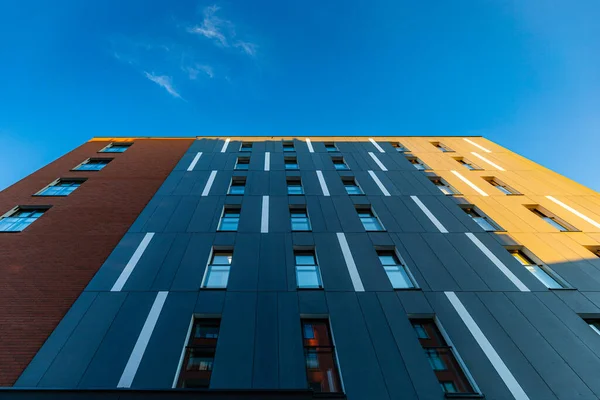 stock image Wroclaw, Poland - June 2022: Facade of modern apartment building with brick and concrete facade and lots of windows on a sunny cloudless afternoon