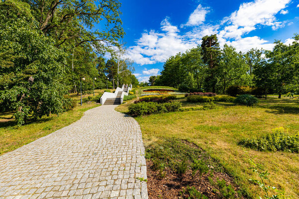Сталова Воля, Польша - июнь 2022 года: красивый, красочный городской парк с искусственной рекой, фонтаном и прогулочными людьми в солнечный день