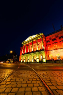 Wroclaw, Polonya - Haziran 2022: Wroclaw Opera Binası Koyu bir yaz akşamında sarı ve kırmızı renkli ışıklarla aydınlatıldı