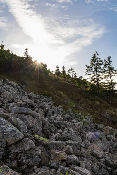 stock image Beautiful landscape of hills and mountains full of green bushes, yellow grass and big rocks at sunny autumn day