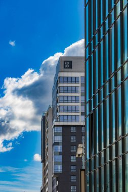 Wroclaw, Polonya - 15 Nisan 2023: Yüksek gökdelen apartmanlı cam cepheli modern şirket binasının cephelerine bakış açısı