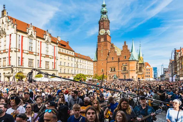 stock image Wroclaw, Poland - May 1 2023: Participants with guitars and observing people around open event Guitar Guinness World Record 2023 where record was beaten with 7967 guitars at market square